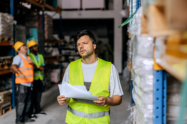 istock Warehouse worker reviewing paperwork near storage shelves 2225213683