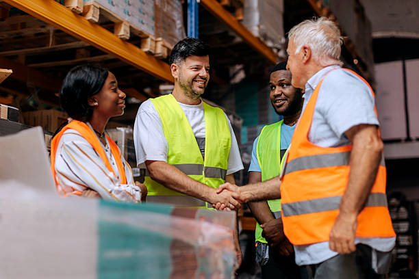 istock Warehouse coworkers shaking hands 2225213688