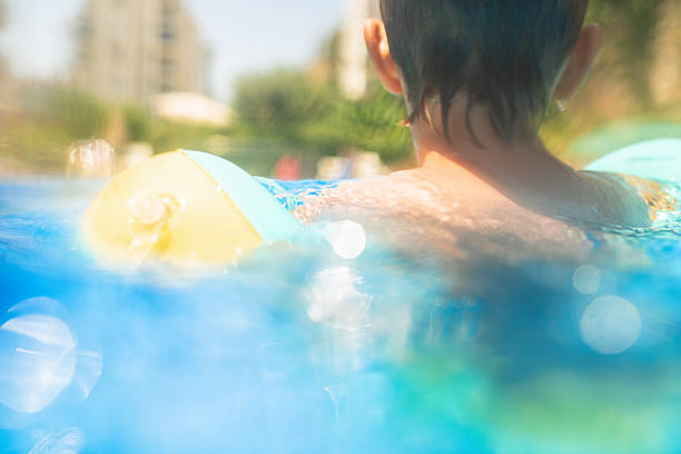 An inviting scene with a green inflatable ring floating in a refreshing blue pool, perfect for enjoying a sunny day