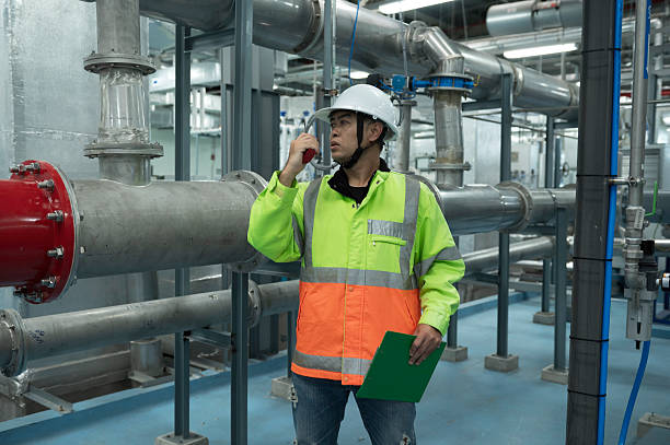 istock Asian Engineer Performing Pipe System Inspection in Modern Industrial Facility. Engineer Monitoring Systems in High-Tech Industrial Facility 2225217386