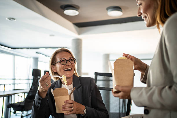 istock Businesswomen having lunch break together at office 2225217556