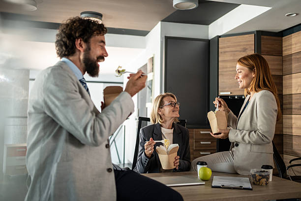 istock Business team enjoying lunch break together in office 2225217584