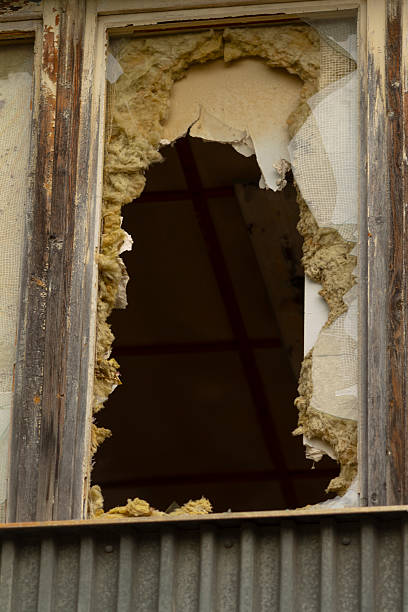 istock A broken window located on a building that has a notable hole in it 2225217590