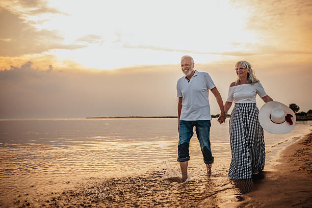 istock Senior couple enjoys a romantic beach walk during sunset while embracing their love and connection on vacation 2225222311