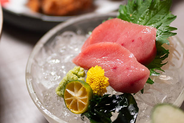 Fresh tuna sashimi served in a decorative bowl.
