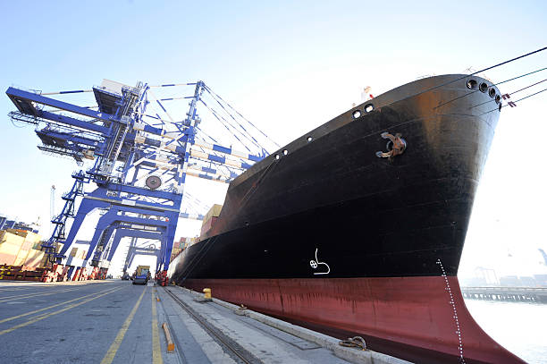 Container ship in port at container terminal. Ships of container ships stand in terminal of port on loading, unloading container