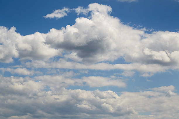 Light Cumulus congestus against the rich blue sky creates a powerful visual dynamic. Used in themes of ecology, weather forecasting, tourism, and life journey.