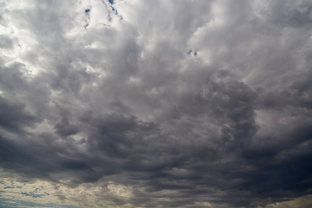 Low storm clouds with distant heavy rain over the sea at Newquay, Cornwall on a bad weather June day.