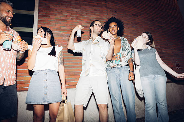 istock Group of friends enjoying snacks and drinks at night 2225226030