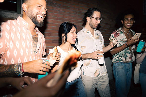 istock Group of friends enjoying snacks and drinks at night 2225226133