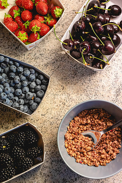 istock Fresh summer berries and granola on stone kitchen counter 2225226310
