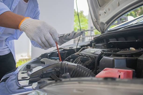 istock Technician in uniform inspecting car with clipboard, focusing on checklist, damage assessment, insurance claim, repair procedure, maintenance report, tools, transportation, expertise, service, office, work, safety 2225226665