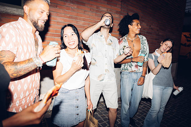 istock Group of friends enjoying snacks and drinks at night 2225227562