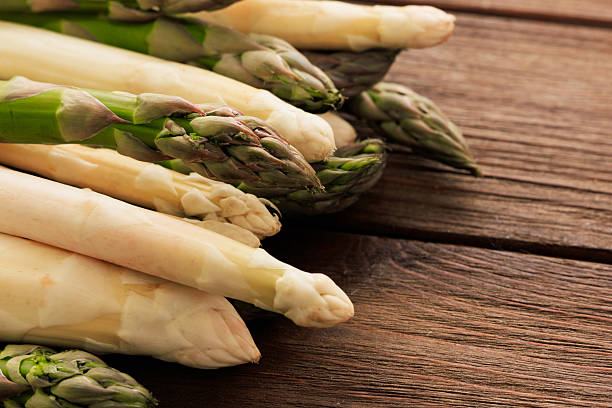 istock Fresh asparagus arranged on a wooden table ready for cooking or meal preparation 2225228741