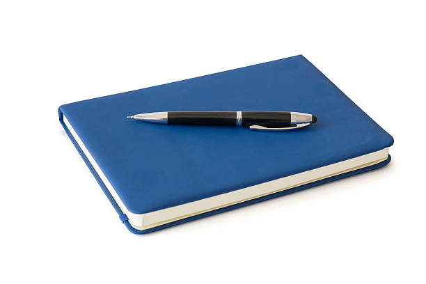 istock A blue notebook and classic black ballpoint pen for business or education notes and planning. Professional office and school supplies concept, isolated on white background with clipping path. 2225230223