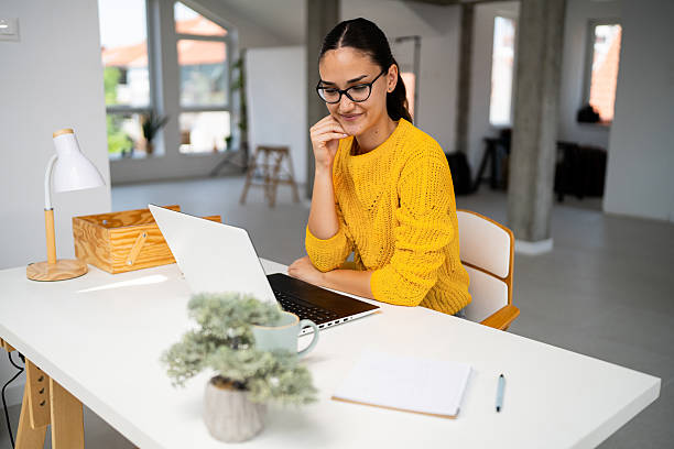 istock Young professional working in a modern office with a laptop 2225230231