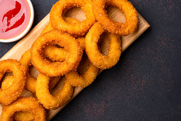 istock Fried onion rings on black background 2225234065