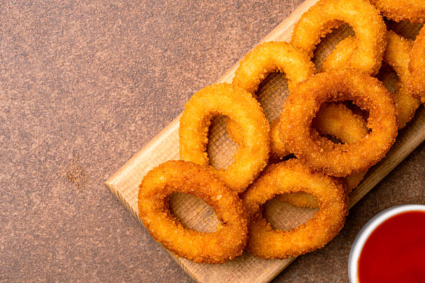 istock Fried onion rings on vintage brown background 2225234066