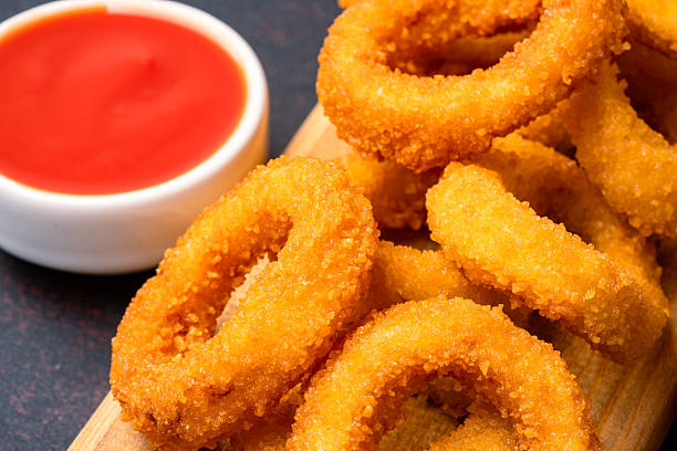 istock Fried onion rings on black background 2225234072
