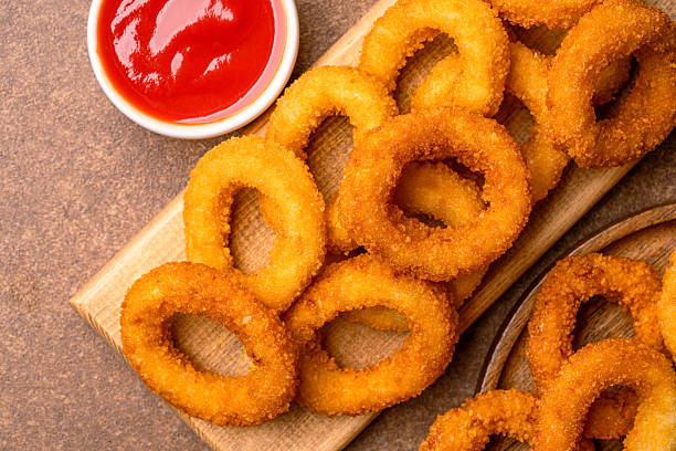 Fried onion rings on vintage brown background