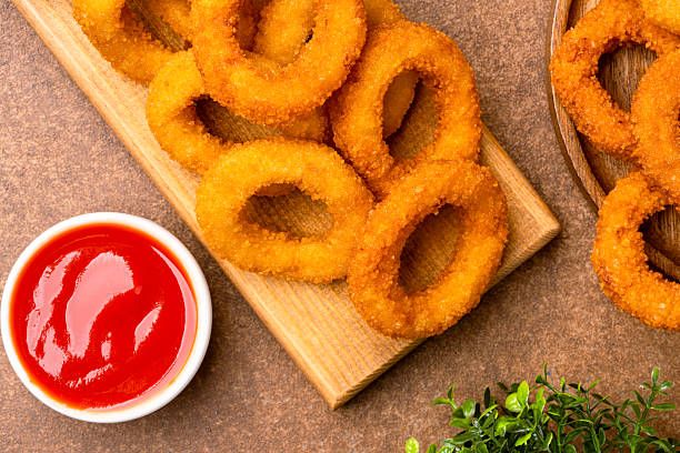 istock Fried onion rings on vintage brown background 2225234117