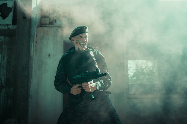 A soldier dressed in camouflage holds a weapon, standing confidently in a smoke-filled environment, symbolizing action, bravery, and combat readiness.