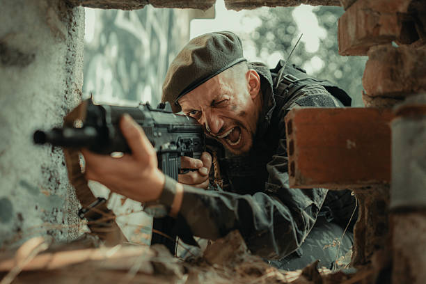 istock Military Operative Shouting While Aiming Rifle During Intense Urban Combat 2225236024