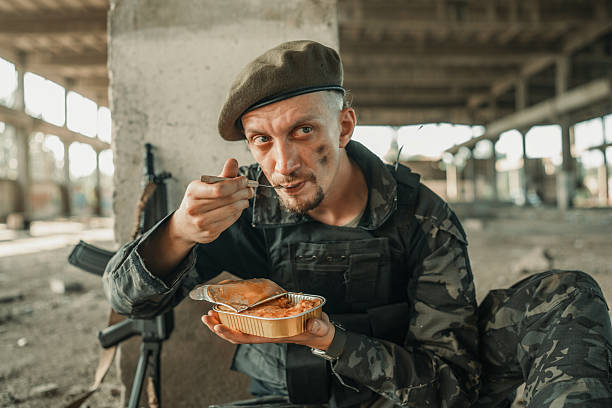 istock Soldier Eating Ration in a Ruined Industrial Setting 2225236046
