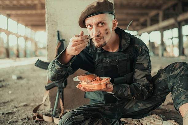 Soldier Enjoying Meal in Abandoned Building During Active Duty