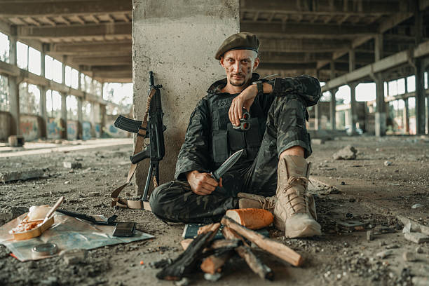 istock Soldier Relaxing in Abandoned Building with Tactical Equipment 2225236090