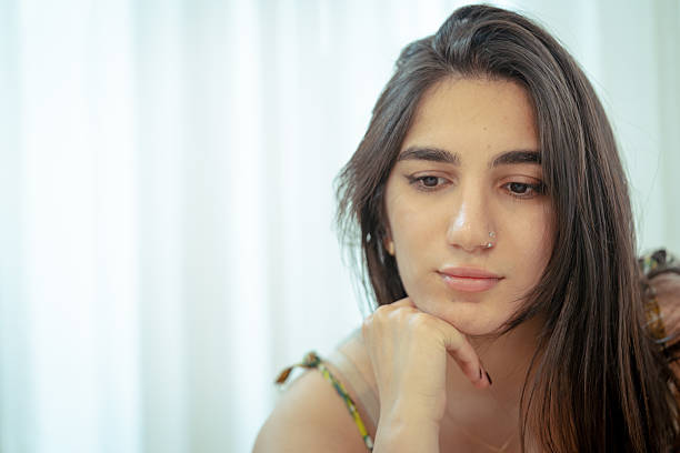 istock Calm young woman thinking and relaxing at home 2225236172