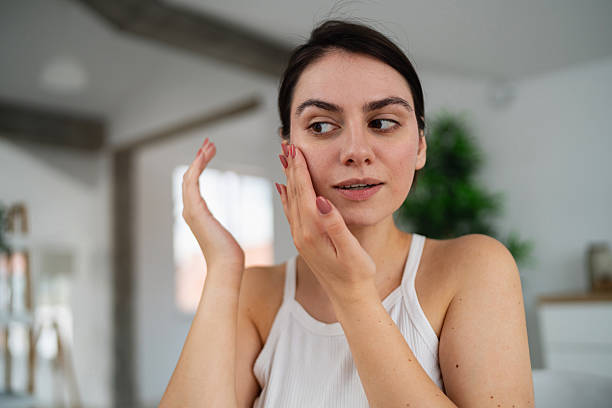 istock Young Caucasian woman applying an face cream 2225237648