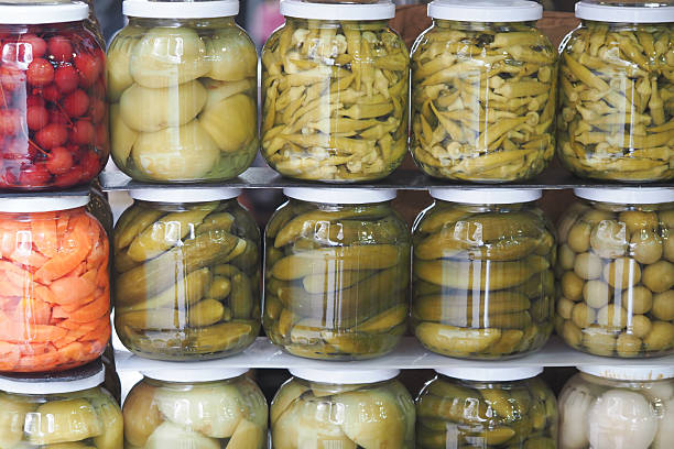 Colorful jars of pickled vegetables displayed at a market