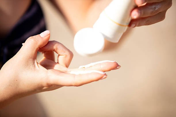 istock Woman applying sunscreen protection cream 2225242164