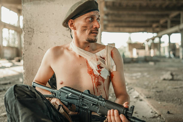 istock Injured Soldier with Rifile in Abandoned Warehouse Setting 2225244948