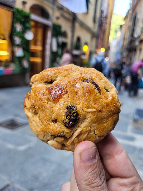 istock Traditional Italian Biscuit with Nuts and Raisins Held in Hand 2225248366