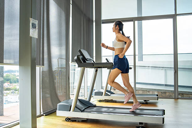 istock athlete woman focused on Treadmill Running 2225249521