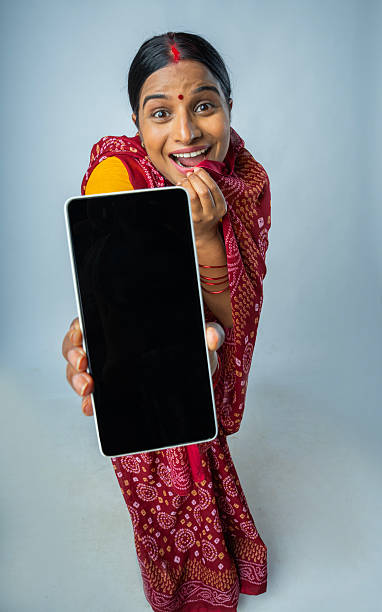 istock Happy woman showing smart phone on white background 2225249534
