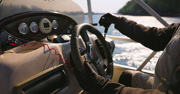 istock Hands of a Man Steering a Boat on a Sunny Day 2225253749