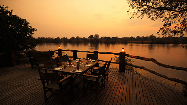 istock Outdoor Dining Setup Overlooking Peaceful River at Sunset 2225254285