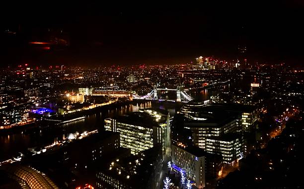 istock Night view across London rooftops with Tower Bridge lit up 2225258308