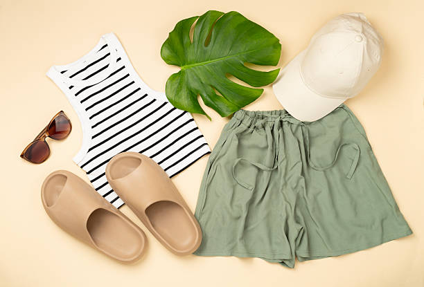 Flat lay with casual summer outfit on color background, top view