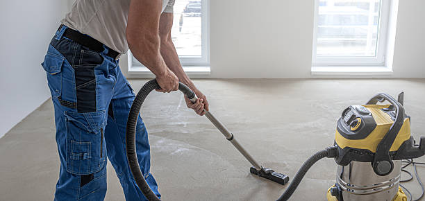 istock Floating floor work. A worker vacuums the floor before laying the vinyl floor layer. 2225262611