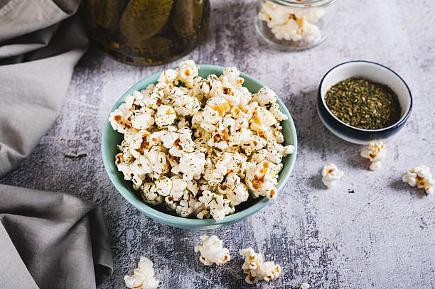 istock Delicious popcorn with dill and pickles in a bowl on the table 2225262976