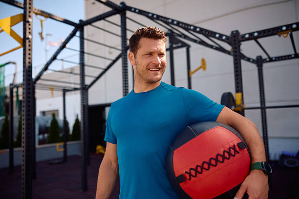 istock Athletic man using medicine ball during outdoor workout and looking away, 2225263519