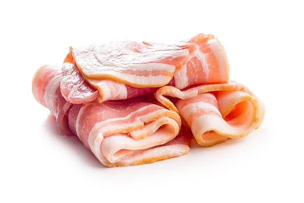 istock Slices of raw bacon isolated on white background. 2225266014