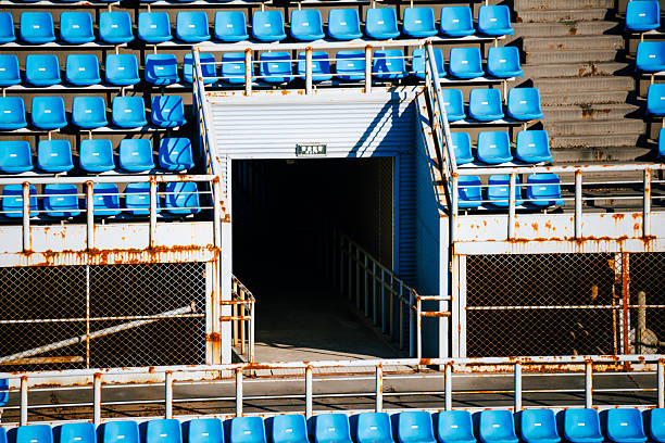 Tighter framing of tunnel portal showing crisp seat rows and metal railings; graphic balance between geometry and texture.