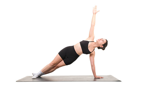 istock yoga teacher performing side plank pose using a mat in a studio environment with a white background 2225268320