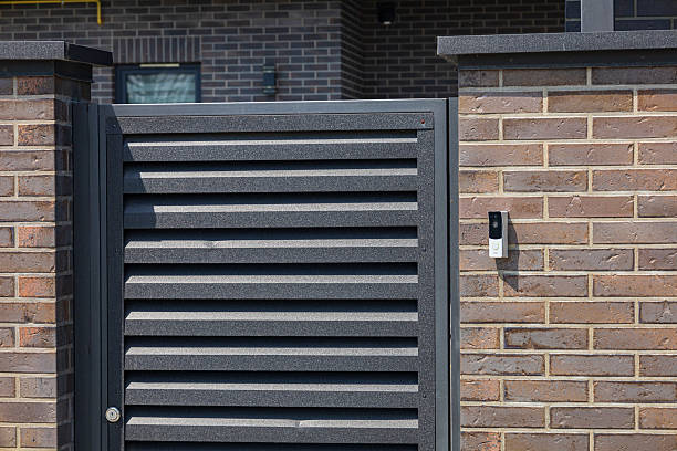 istock A contemporary gate features horizontal slats, blending style with security in an urban neighborhood during daylight hours 2225270685