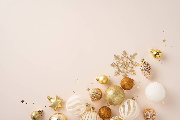 istock Festive gold and white decorative holiday ornaments scattered on a neutral beige surface capturing the spirit of Christmas celebrations and seasonal festivities 2225270768